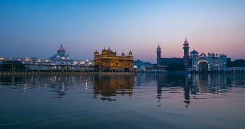 The Golden Temple at Amritsar, Punjab, India, the most sacred icon and worship place of Sikh religion. Time lapse fading from dawn to sunrise.