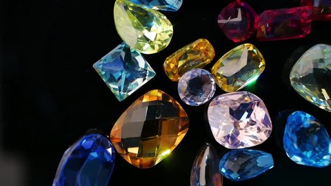 Jewel or gems on black shine table, Collection of many different natural gemstones amethyst, lapis lazuli, rose quartz, citrine, ruby, amazonite, moonstone, labradorite, chalcedony, blue topaz
