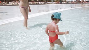 Little girl playing in outdoor swimming pool, slow motion full HD clip