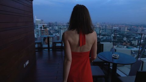 Elegant, young woman walking on terrace in bar, super slow motion 240fps
