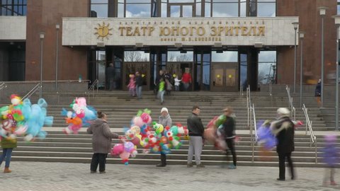Time-lapse recording. The audience, parents and children out of the theatre after the show. At the entrance sold colorful balloons. Theatre of the young spectator. Russia, Saratov, March 26, 2017