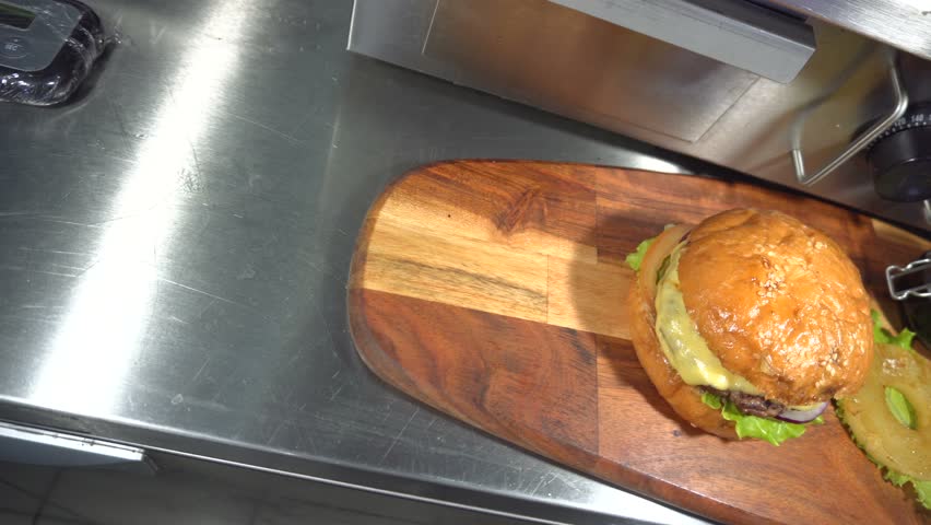 Tasty burger with cheese, lettuce, onion, tomatoes and pineapple.