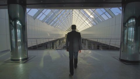 The businessman walk in the business center balcony. Slow motion