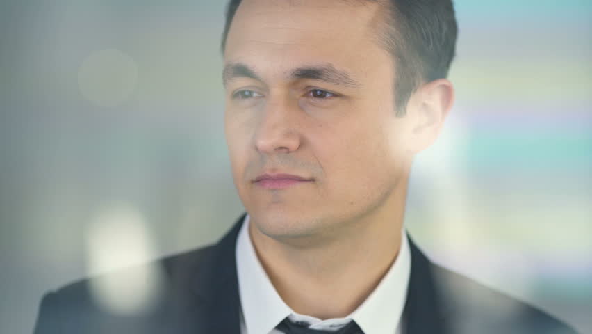 The businessman smile over the glass 