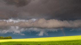 Alarming view of the vivid lawn and dark ominous clouds. Dramatic and mystery scene. Wonderful natural background. Beauty world. Climate change. Time lapse clip, interval shooting in HD 1080 video.
