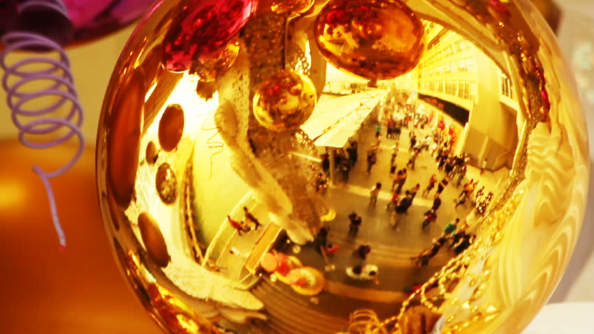 Christmas decorations mirror - reflection of people rushing around the shopping