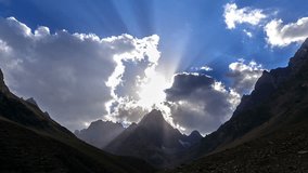Peaks in the clouds at sunset Pamir, Tajikistan.