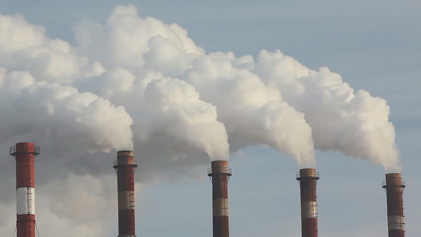 five chimneys producing thick white smoke