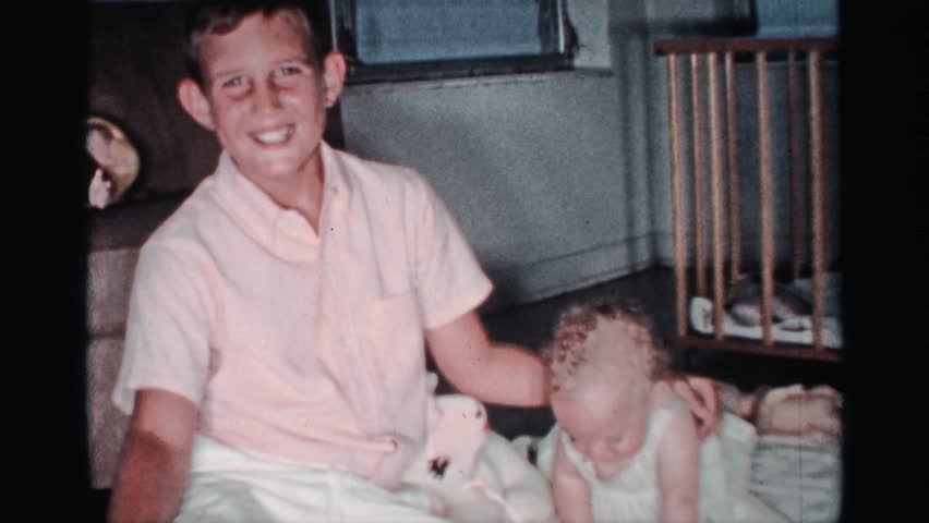 MINNESOTA 1959: a small boy play in our sister in house morning time in a house happy time