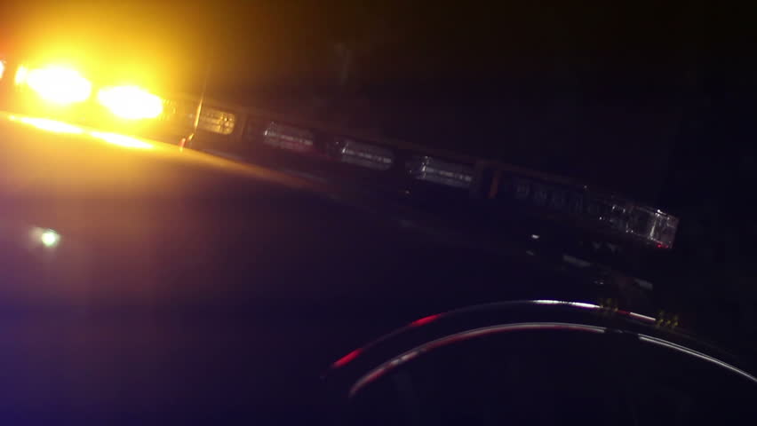 A collection of two close-up shots of a police car's flashing lights.  Both