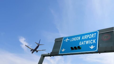 airplane flying over london gatwick airport sign