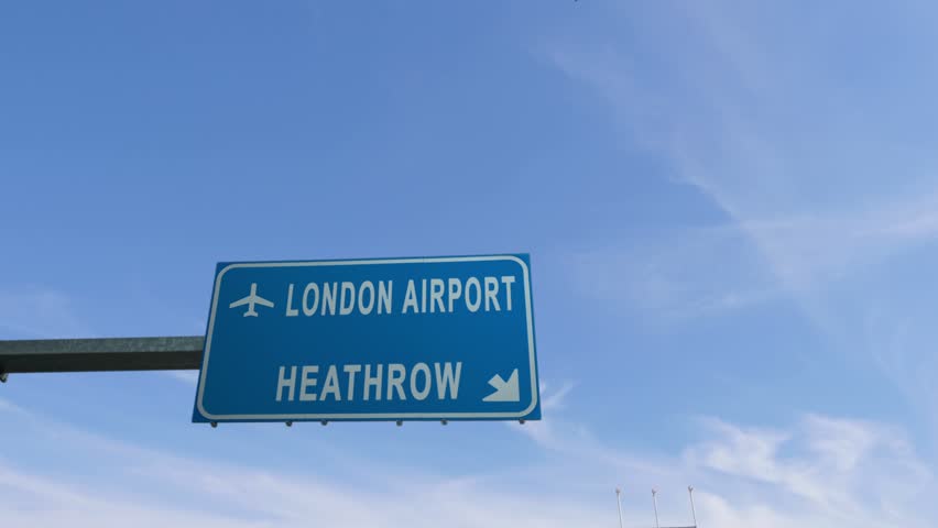london heathrow airport sign airplane passing overhead Royalty-Free Stock Footage #25267199