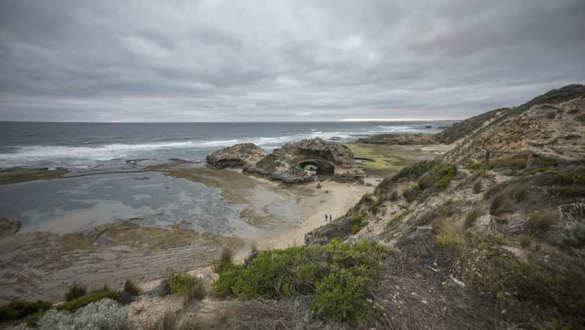 Time lapse of cloudy sunset at unique rock formation along the coastline - The London Bridge at portsea, Mornington Peninsula, Victoria Australia. 