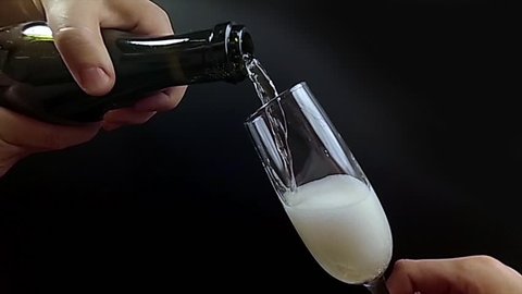 Waiter pours champagne into a glass, super slow motion 240 fps hd video