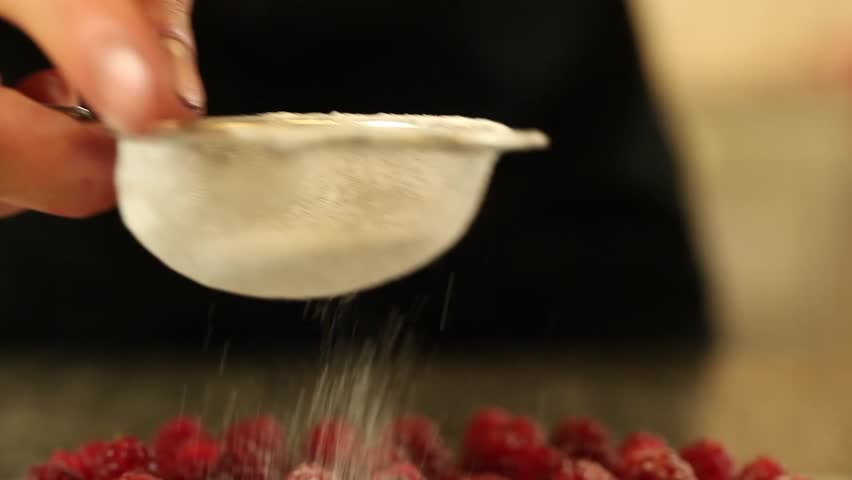 sugar falls on raspberry tart