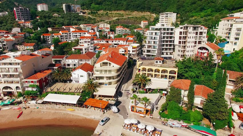 Settlement Rafailovici, Budva Riviera, Montenegro. The coast of the city on the Adriatic Sea. Aerial photography. Boats at sea, hotels, villas and apartments on the coast. | Shutterstock HD Video #25282376