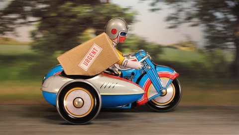Tin toy Delivery motorbike and sidecar speeding along a rural road with an urgent parcel.
