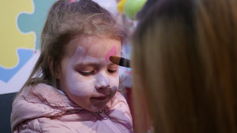 Painting Body Art On A Face Of Little Child Girl 스톡 비디오