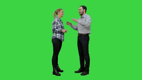 Couple of lovers stand, talk, laugh on a Green Screen, Chroma Key.