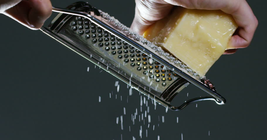 Slow motion of A cook grater Parmesan cheese, typical Italian cheese, on the plate just freshly brewed. Concept: Italian cuisine, cheese, restaurant and food. Royalty-Free Stock Footage #25291253