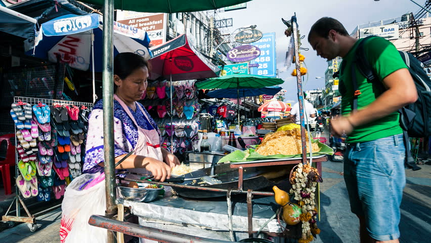 BANGKOK - July 08, 2012: Timelapse view of a woman selling Phat That (Thai fried