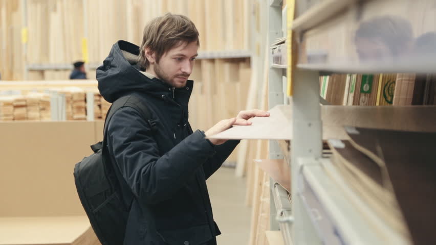 Man chooses products in the build supermarket