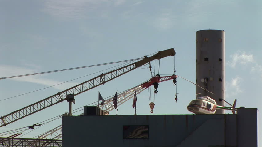 A small helicopter stationed atop an old drilling platform.