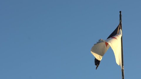 Slow motion Templar banner wind and blue sky in Castle Medieval Of The Knights Of Templars at Jerez de los Caballeros, Spain.-Dan