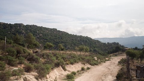 4k shot from a camera attached to the side of an off road campervan driving on rough tracks in sardinia, italy