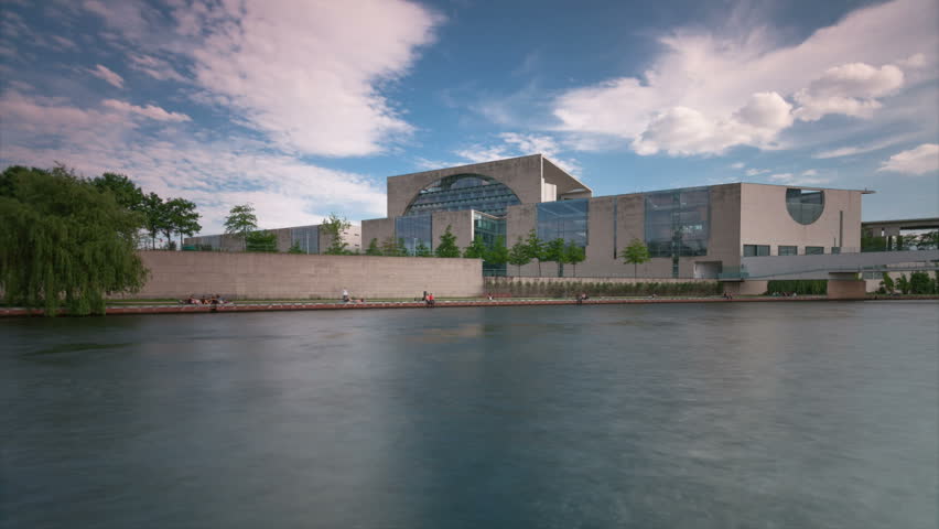 The Bundeskanzleramt (Kanzleramt) with dynamic Spree River Speed Boats in 1080p FullHD - famous landmark in Berlin, Germany