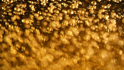 A lot of bubbles in the yellow liquid, slowly rising and bursting, liquid is like beer or oil or drink or fuel, can be applied in any version