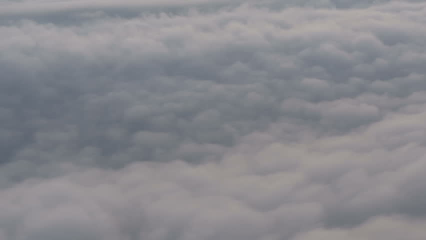 Airplane flying over clouds.Filmed from commercial jet airplane window.