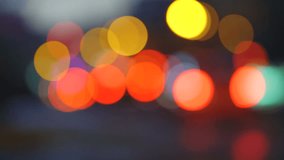 Colorful traffic lights bokeh circles on night city street. Abstract background