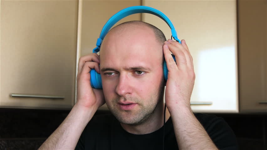 Man in headphones jumping to energetic music