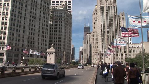 Chicago, IL - CIRCA September 2007: City traffic crosses a bridge and passes many flapping flags in order to get over the Chicago River during the day