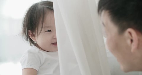 slow motion, little cheerful Asian girl playing with her parents ,moments of happiness in the family