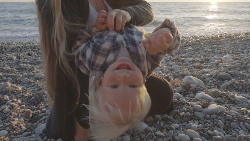 Mom and son having fun on the beach