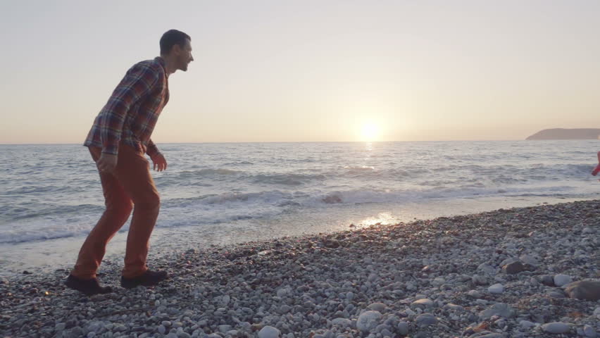 Dad and daughter having fun on the beach