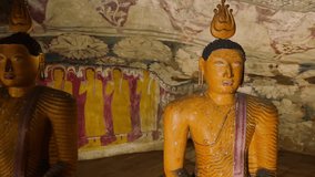 Beautiful ancient Buddhist statues and Buddha monuments in Dambulla cave temple interior with traditional architecture in Sri Lanka. Asia landmarks video background