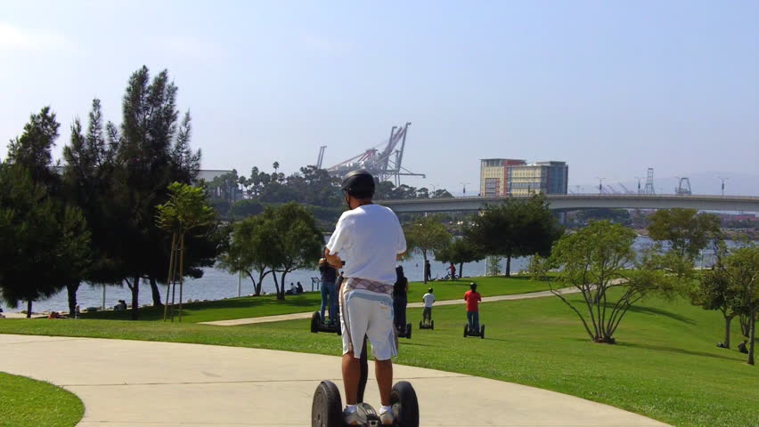 LONG BEACH, CA - CIRCA 2006: A group of people ride Segways or Segues away from