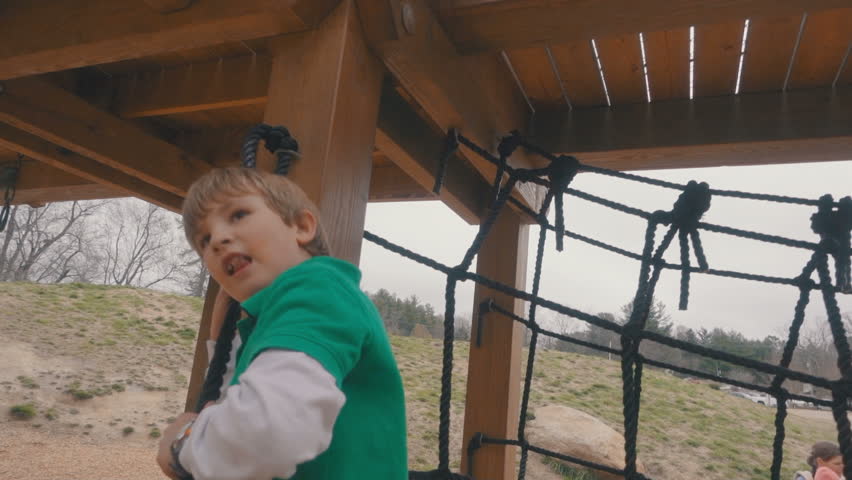 Little blond boy playing on playground. Young children having run playing together on playground unafraid of Covid19. Happy children at outdoors play area together.