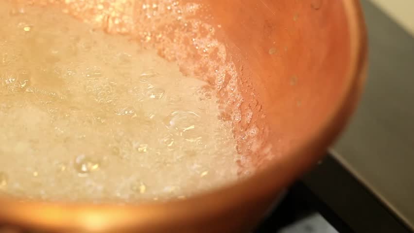 sugar cooking in a copper pot