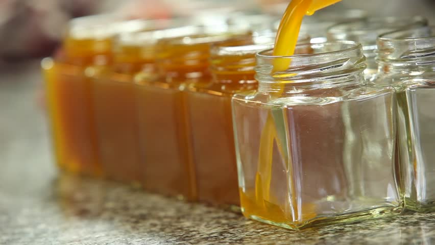 Orange marmalade pouring in a jar