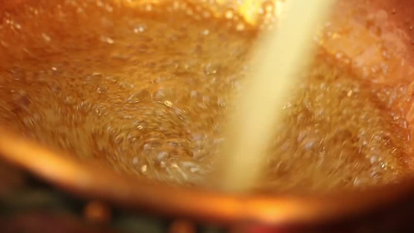 sugar turning into caramel in a copper pot