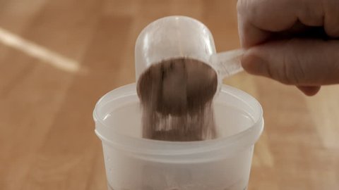 Diet shake powder gets mixed with water in a shaker. Weight loss concept.