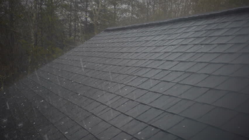 Slow motion of hail hitting home roof in thunderstorm. Roof damage from hail hitting shingles on home roof. Thunderstorm cause damage to house.  Royalty-Free Stock Footage #25374395