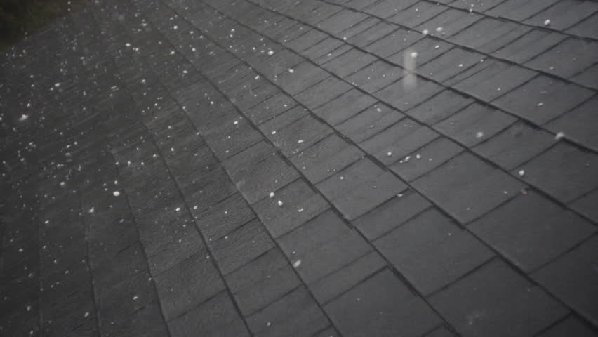 Slow motion of hail hitting home roof in thunderstorm. Roof damage from hail. Hail storm hitting house roof. Roof damage from thunderstorm. Mother nature causing damage to house.  Royalty-Free Stock Footage #25374401