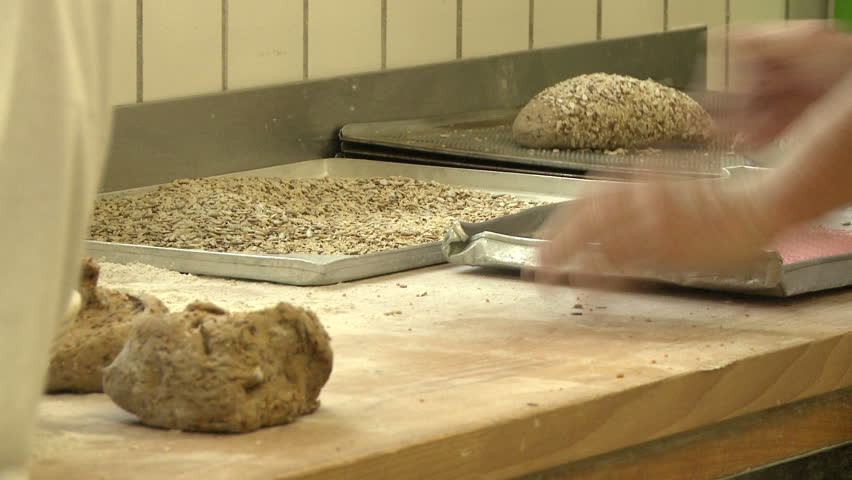 Baker working with fresh dough by hand