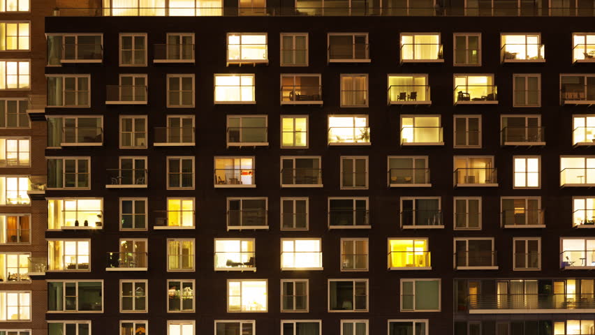 Time-lapse of the exterior of a modern apartment block at night Royalty-Free Stock Footage #25375199