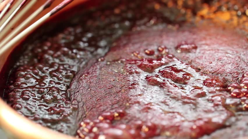 stirring red fruit marmalade